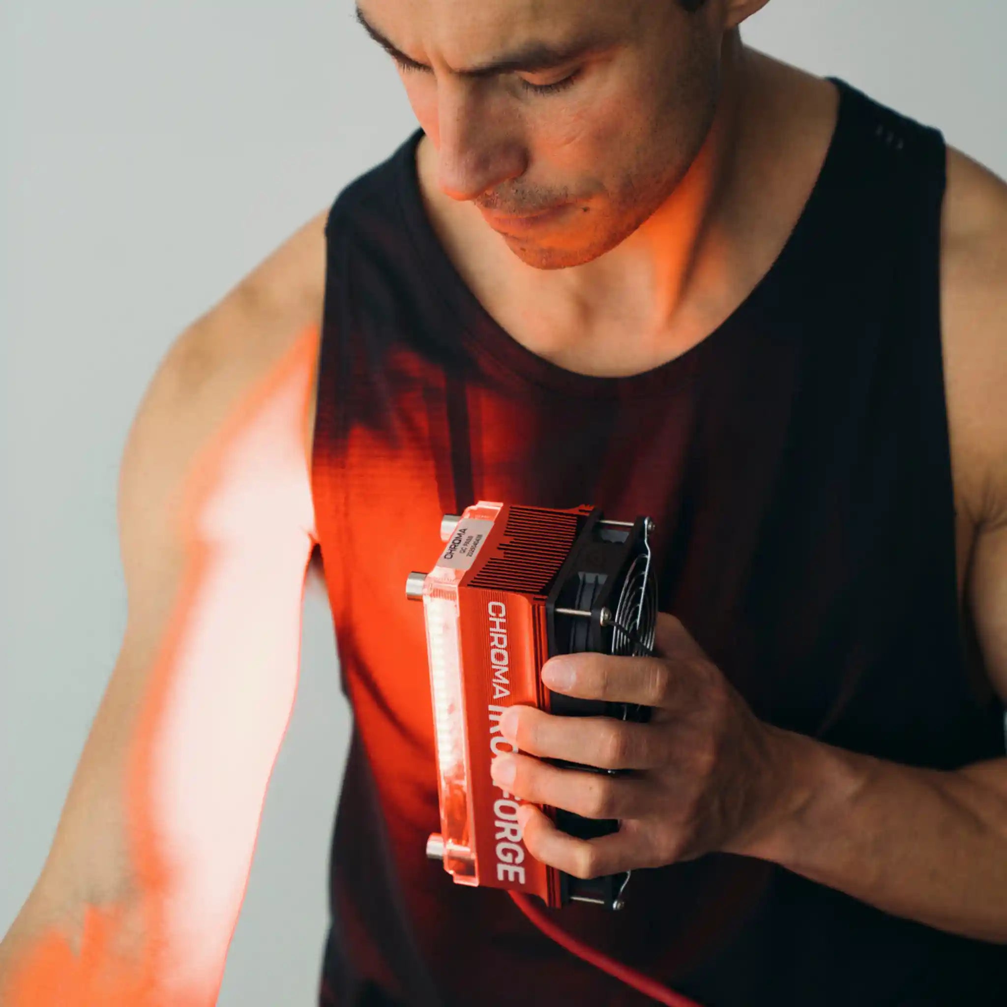 Chroma Ironforge Light Therapy Device in use by male athlete, front facing to depict targeted recovery method.