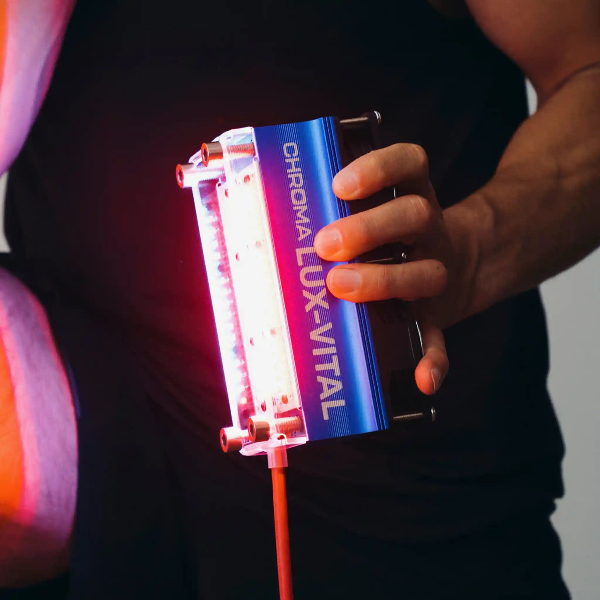 Person holding a Chroma Lux-Vital light therapy device