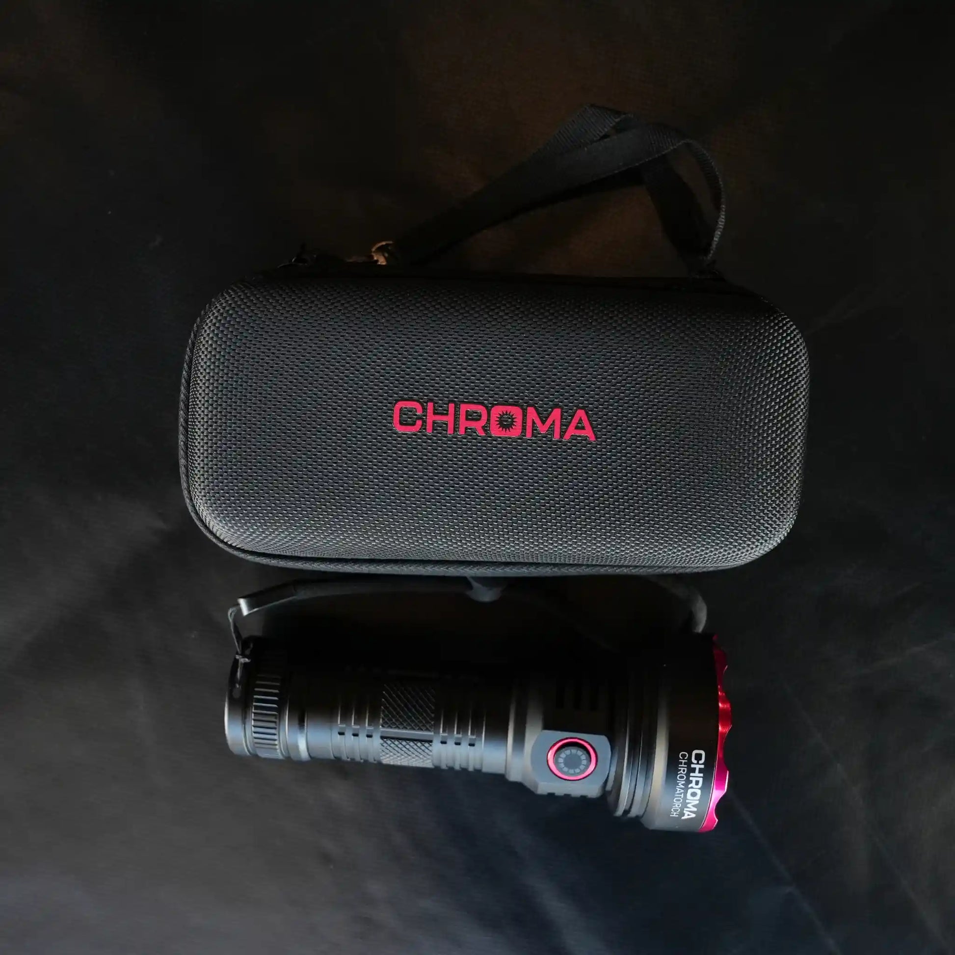 Black flashlight (Chromatorch) and case with 'Chroma' branding on a dark background