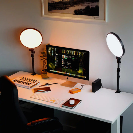 Modern home office setup with a desk, computer monitor, keyboard, mouse, and two Chroma Sky Portal light devices.