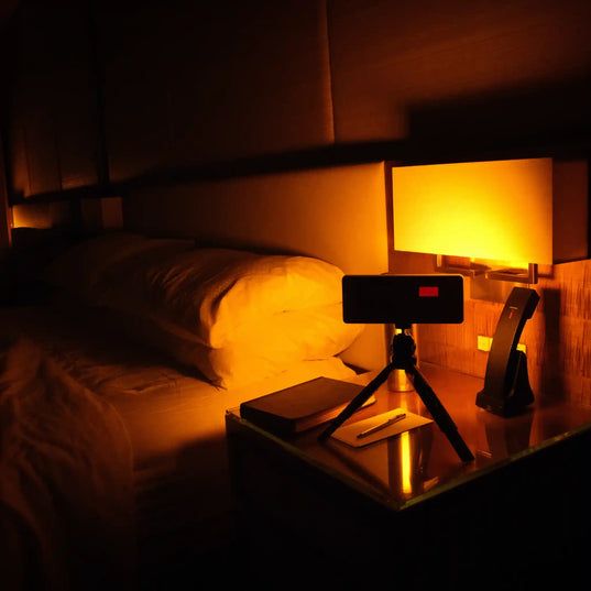 Chroma Sky Portal Mini on a nightstand next to a bed in a dimly lit room