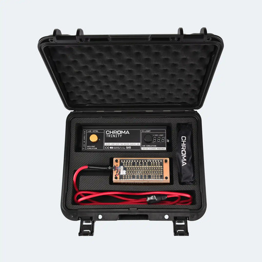 Black travel case with electronic components (Chroma trinity light therapy device) and Chroma branding on a light gray background