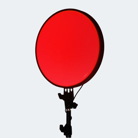 Chroma Red Portal light device with a black stand on a white background