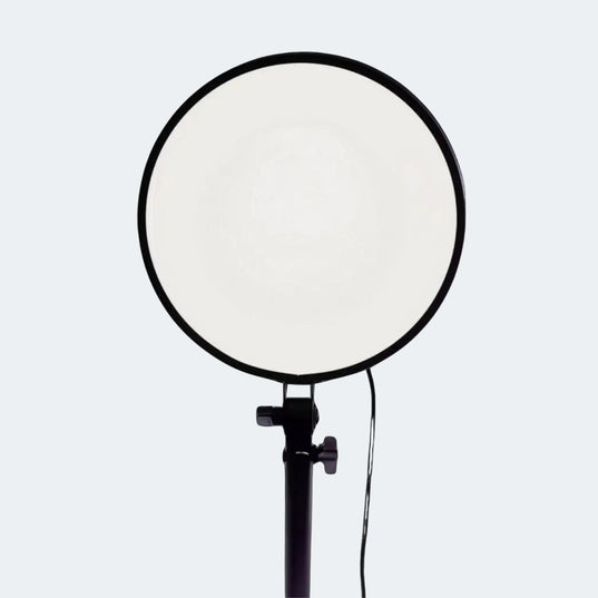 Chroma Sky Portal light device on a black stand on a white background